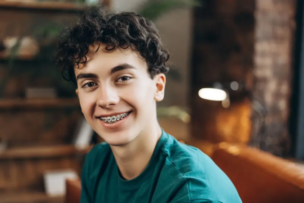 Smiling teen wearing metal braces